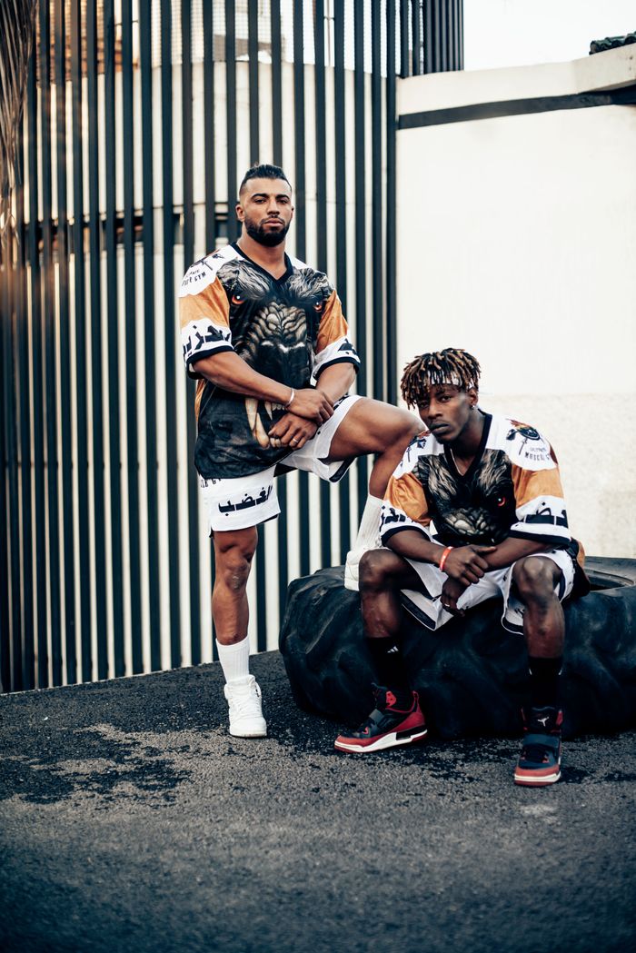 Two male musicians posing outdoors in trendy urban sportswear outfits in Rabat, Morocco.